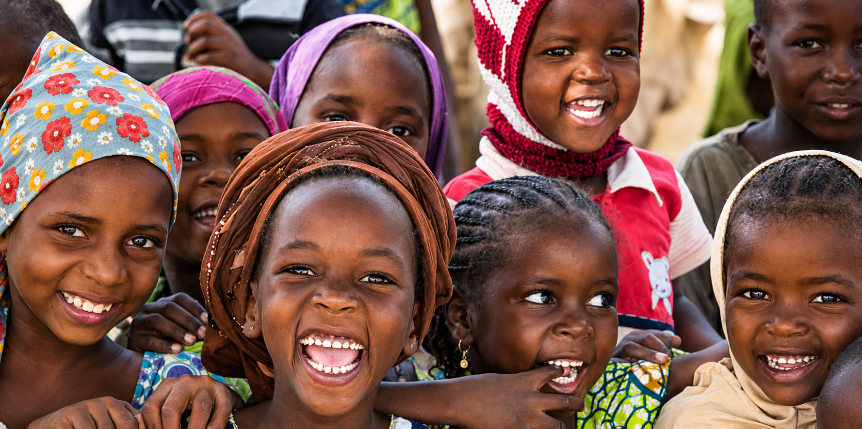 A group of children laughing and smiling together